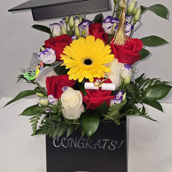 Graduation bouquet in a black box with roses and a yellow gerbera daisy
