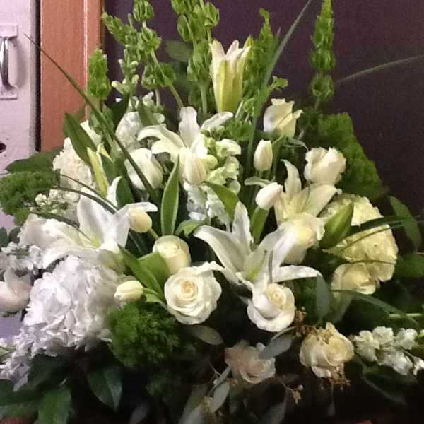 White floral arrangement with lilies and roses in a vase