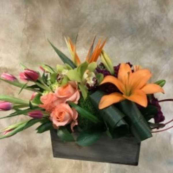 Mixed bouquet with orange lilies, pink roses, and tulips in a black box