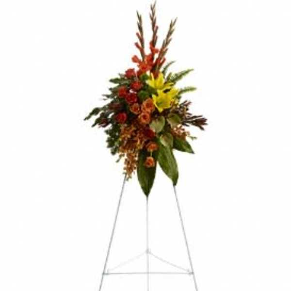 Tall floral spray with red, yellow, and orange flowers on a metal stand