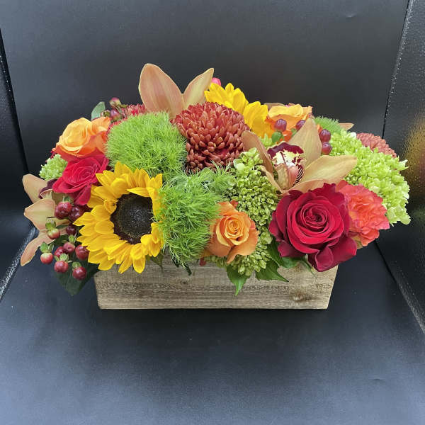 Colorful mixed flower arrangement in a rectangular wooden box