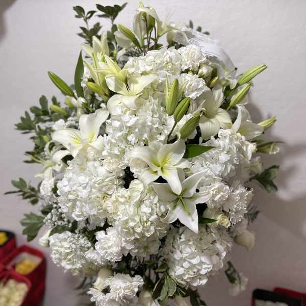 White lily and hydrangea standing arrangement on a metal easel