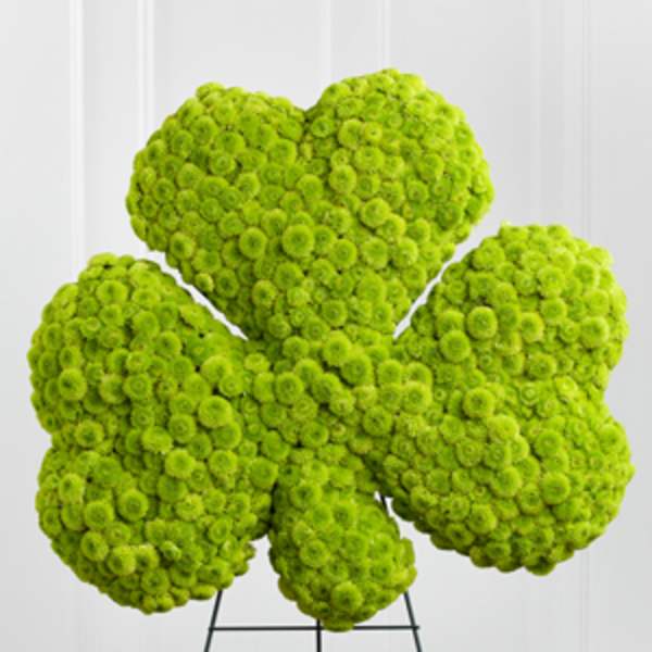 Bright green floral arrangement shaped like a flower on a stand