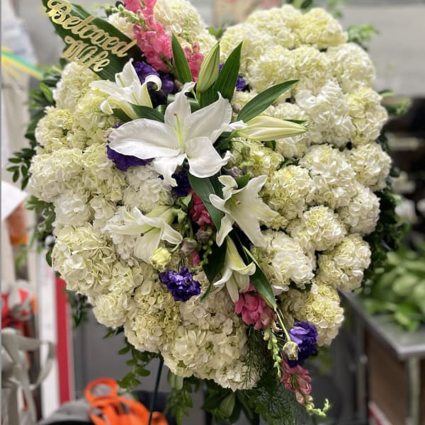 Large standing floral spray with white lilies and cream hydrangeas