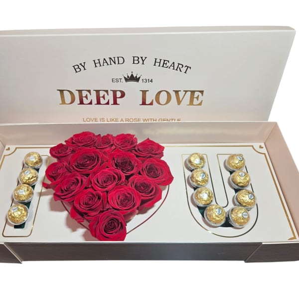 Heart-shaped red rose arrangement in a gift box with chocolates