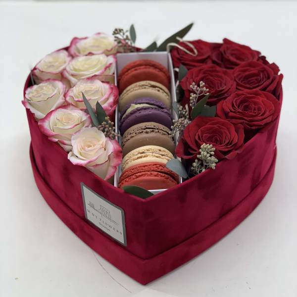 Heart-shaped box with red and white roses and macarons