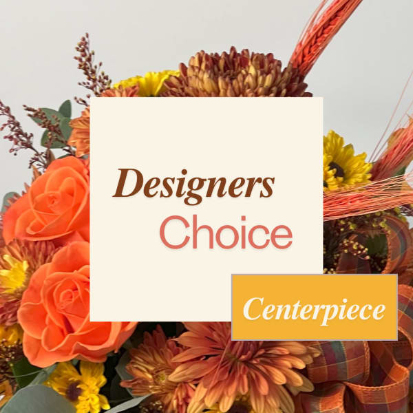 Orange roses and mums arranged with a ribboned centerpiece sign