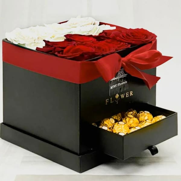 Red and white roses in a black gift box with a drawer of chocolates