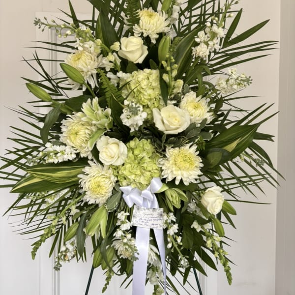 Standing floral spray with white roses and pale green blooms