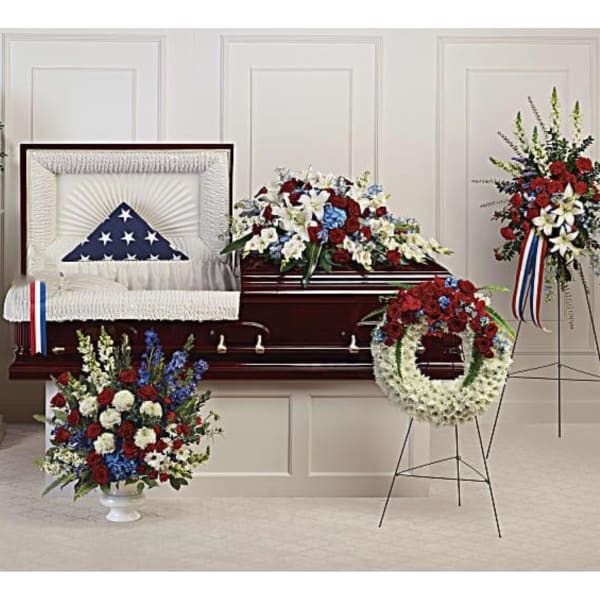 Funeral casket with patriotic floral sprays and wreaths