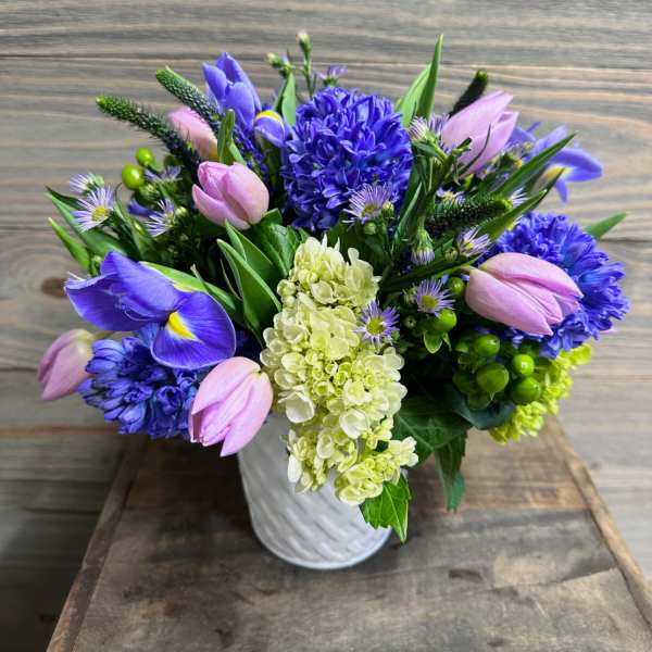Bouquet of purple and pink flowers in a white vase