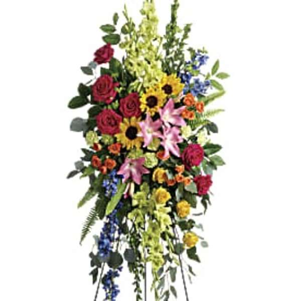 Tall standing floral spray with roses, lilies, sunflowers, and mixed blooms