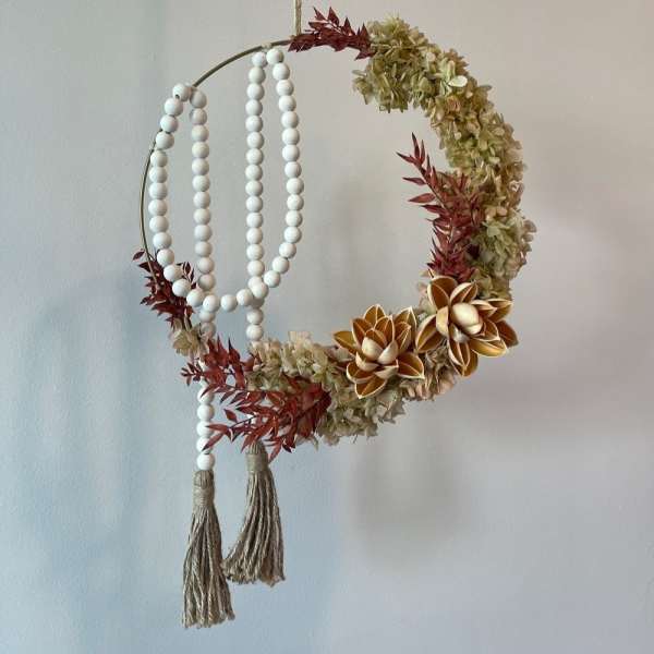 Circular hanging floral hoop with cream blooms and white bead strands