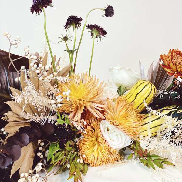 Autumn floral arrangement with yellow chrysanthemums and white roses
