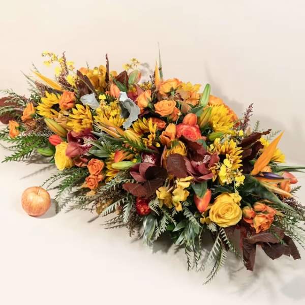 Autumn floral centerpiece with orange and yellow blooms