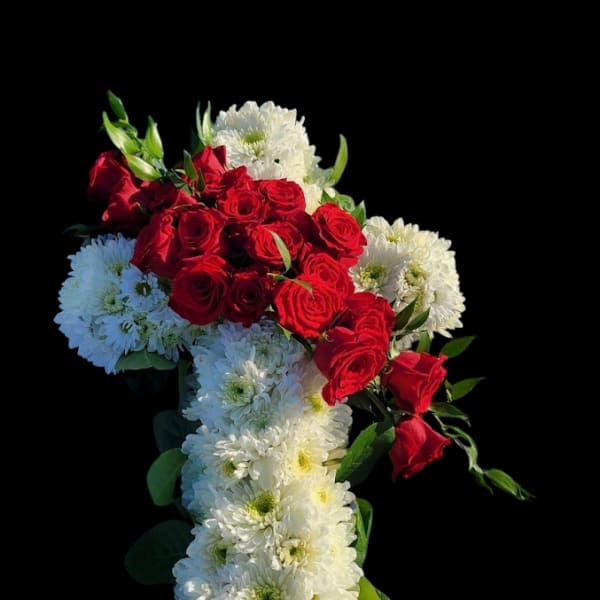 Red roses and white chrysanthemums arranged in a cross shape