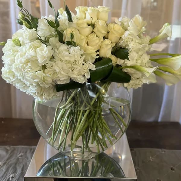 White floral arrangement in a clear glass vase