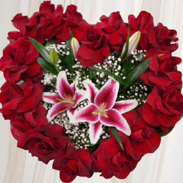 Heart-shaped bouquet of red roses with pink lilies