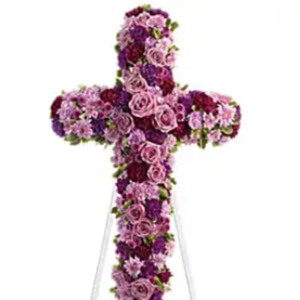 Purple and pink floral cross on a stand