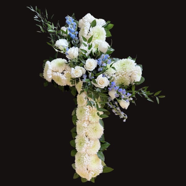 White floral cross with blue accents on a black background