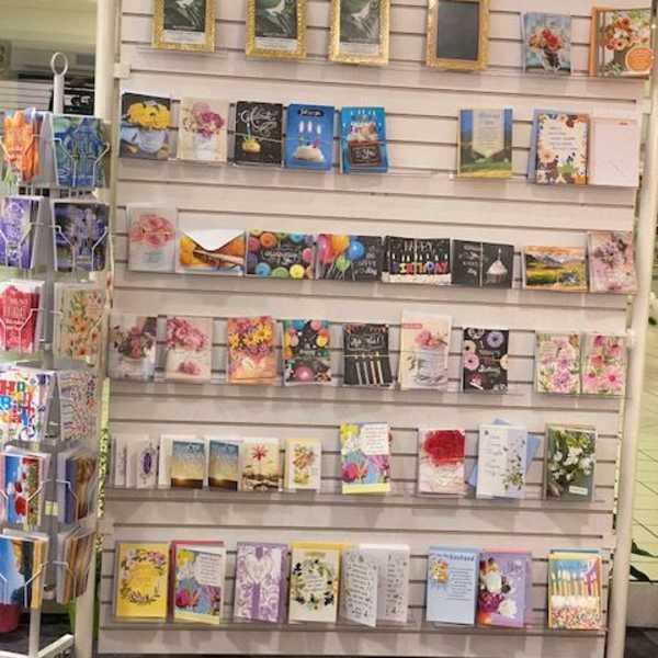 Greeting cards displayed on a store rack.