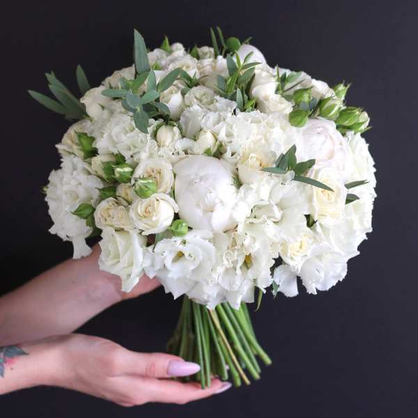 White bouquet with roses, carnations, and greenery