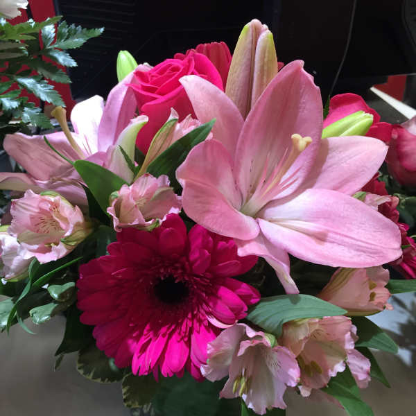 Pink lilies and gerbera daisies in a mixed bouquet