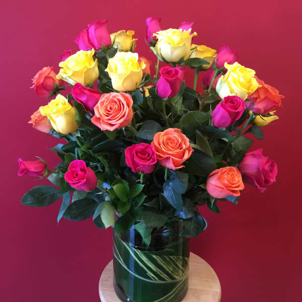 Bouquet of multicolored roses in a glass vase
