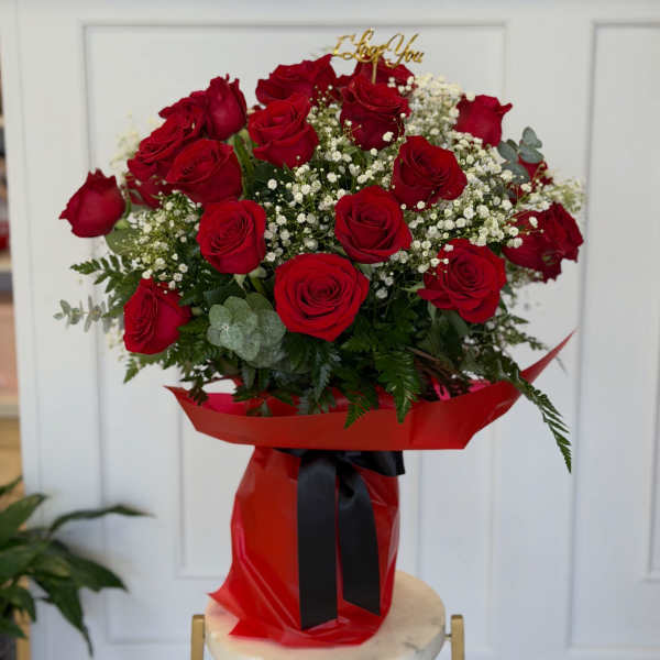 Bouquet of red roses with baby's breath in red wrap