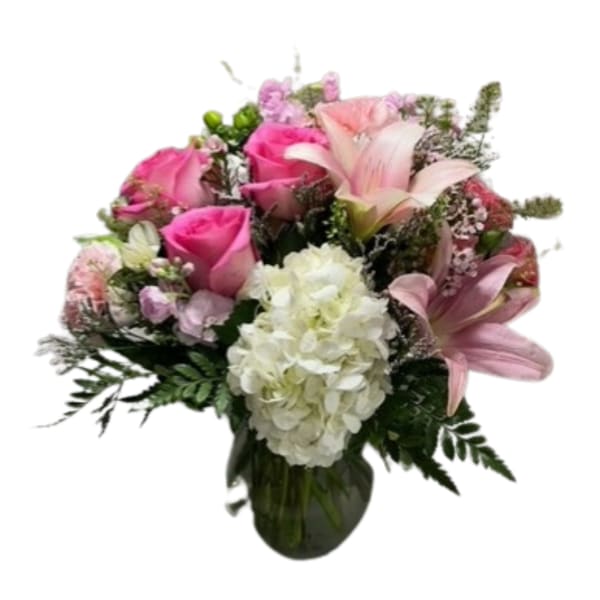Pink roses and lilies with white hydrangea in a glass vase