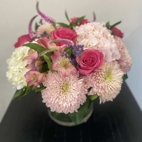 Pink roses and pale chrysanthemums in a glass vase