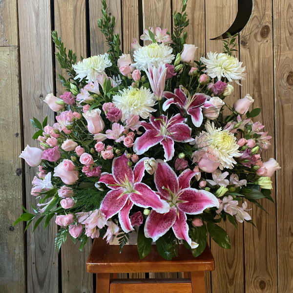 Large pink and white floral arrangement with lilies and roses