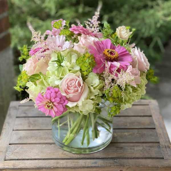 Pink and cream bouquet in a clear glass vase