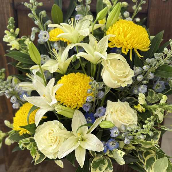 Bouquet of white lilies, cream roses, and yellow chrysanthemums