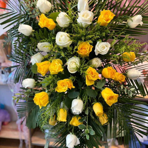 Yellow and white rose standing spray with palm fronds