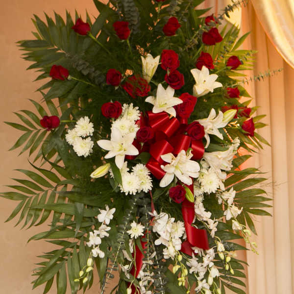 Tall standing floral spray with red roses and white lilies