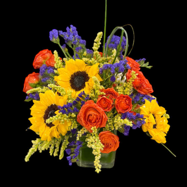 Bouquet of sunflowers and orange roses in a glass vase