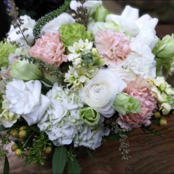 Bouquet of white and blush flowers with green accents