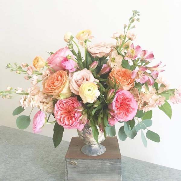 Pastel mixed flower arrangement in a silver vase