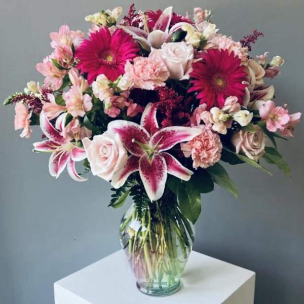 Pink and white mixed bouquet in a clear glass vase