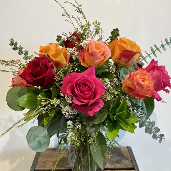 Bouquet of multicolored roses in a glass vase