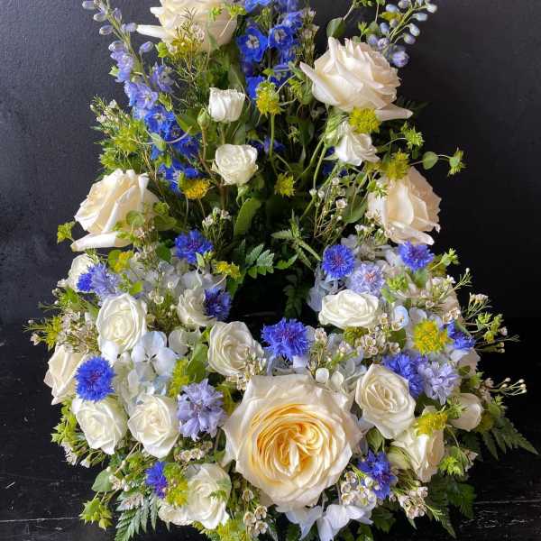 White and blue floral wreath with roses and small filler blooms