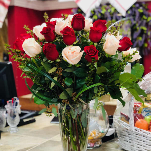 Bouquet of red and white roses in a clear glass vase