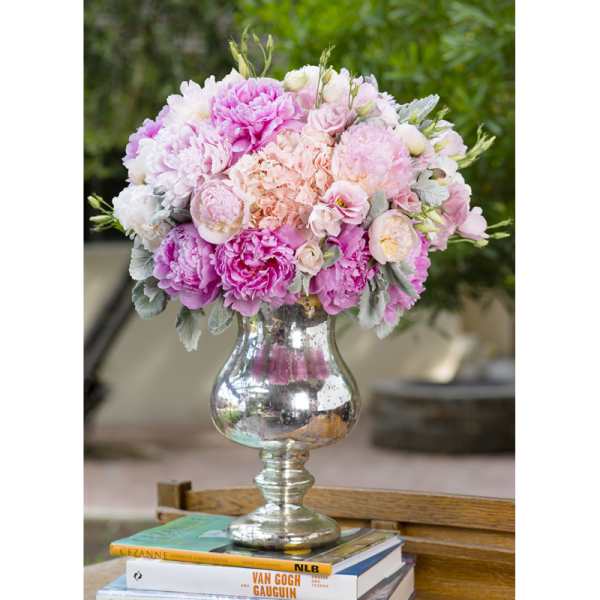 Pink and white floral arrangement in a silver vase