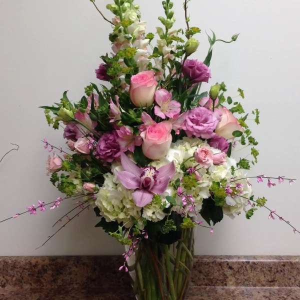 Tall mixed bouquet in a glass vase with pink and white flowers