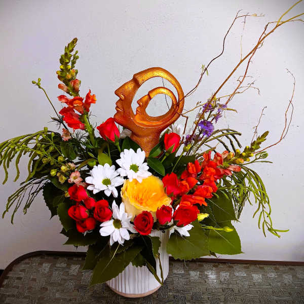 Mixed bouquet in a white vase with red, white, and yellow flowers