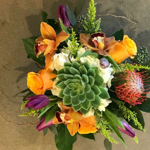 Bouquet with orange orchids, purple tulips, and a green succulent center