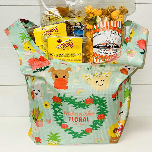 Gift tote filled with assorted packaged snacks and popcorn