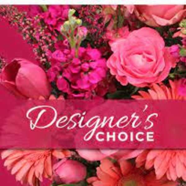 Pink floral arrangement with roses and daisies labeled Designer's Choice