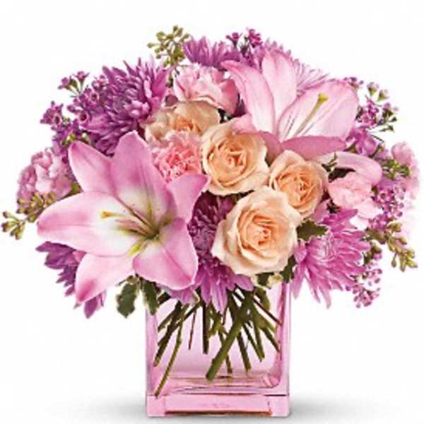 Pink lilies and roses in a pink glass vase